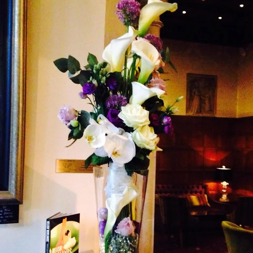 A vase filled with flowers sitting on top of a table.
